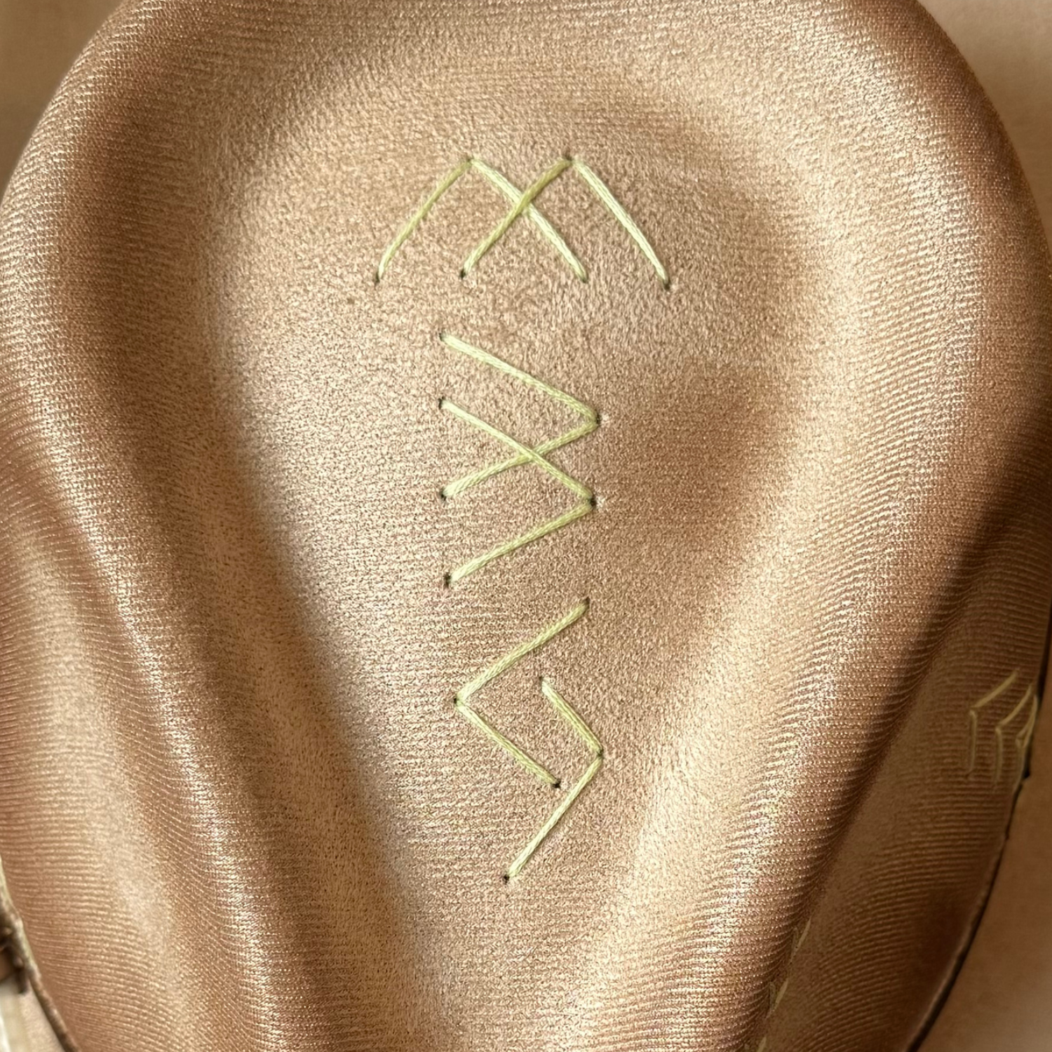 Close-up of “M B S” embroidery on crown top