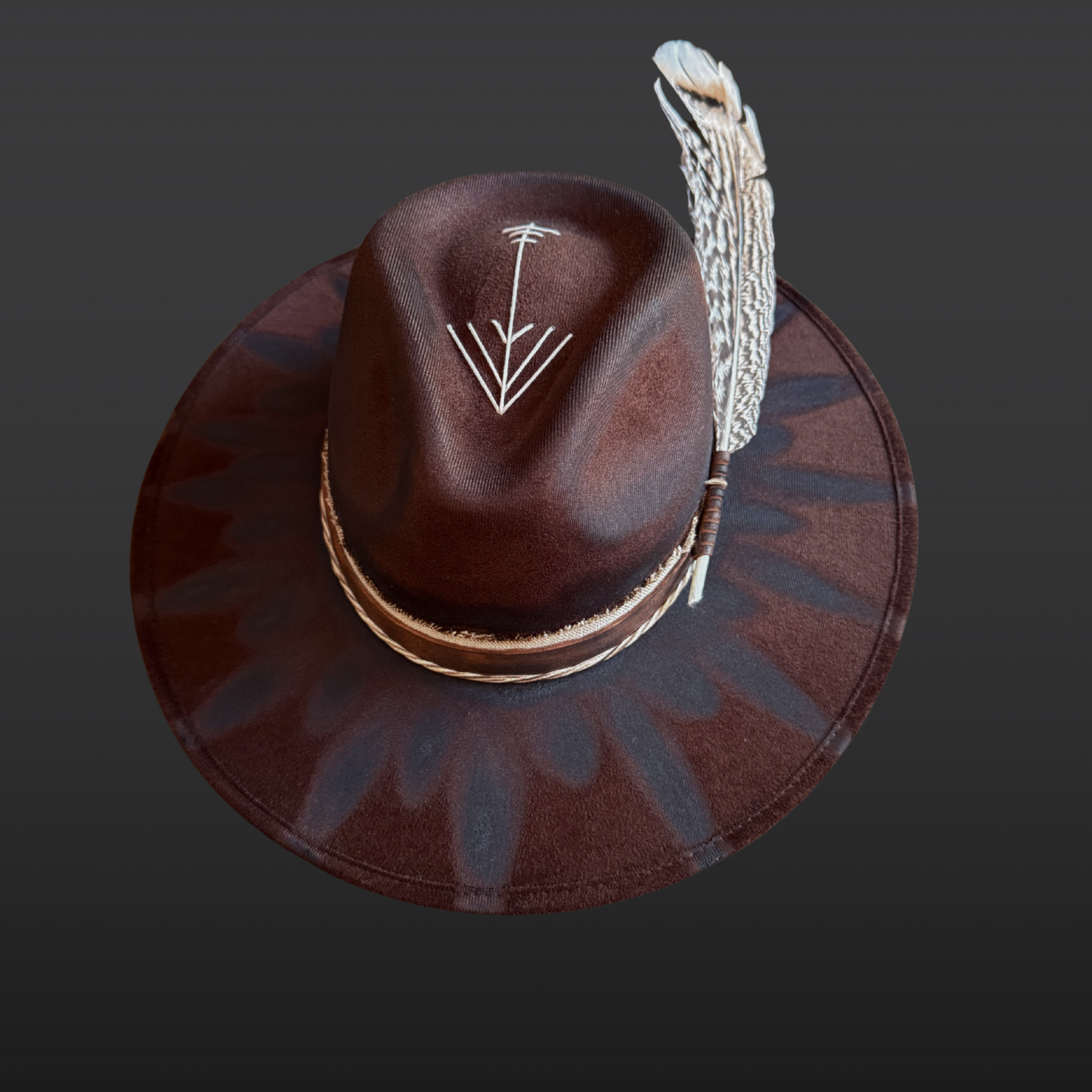 Top profile of brown wide brim fedora hat showing feather embellishment, torch-burned detailing, and handcrafted boho design