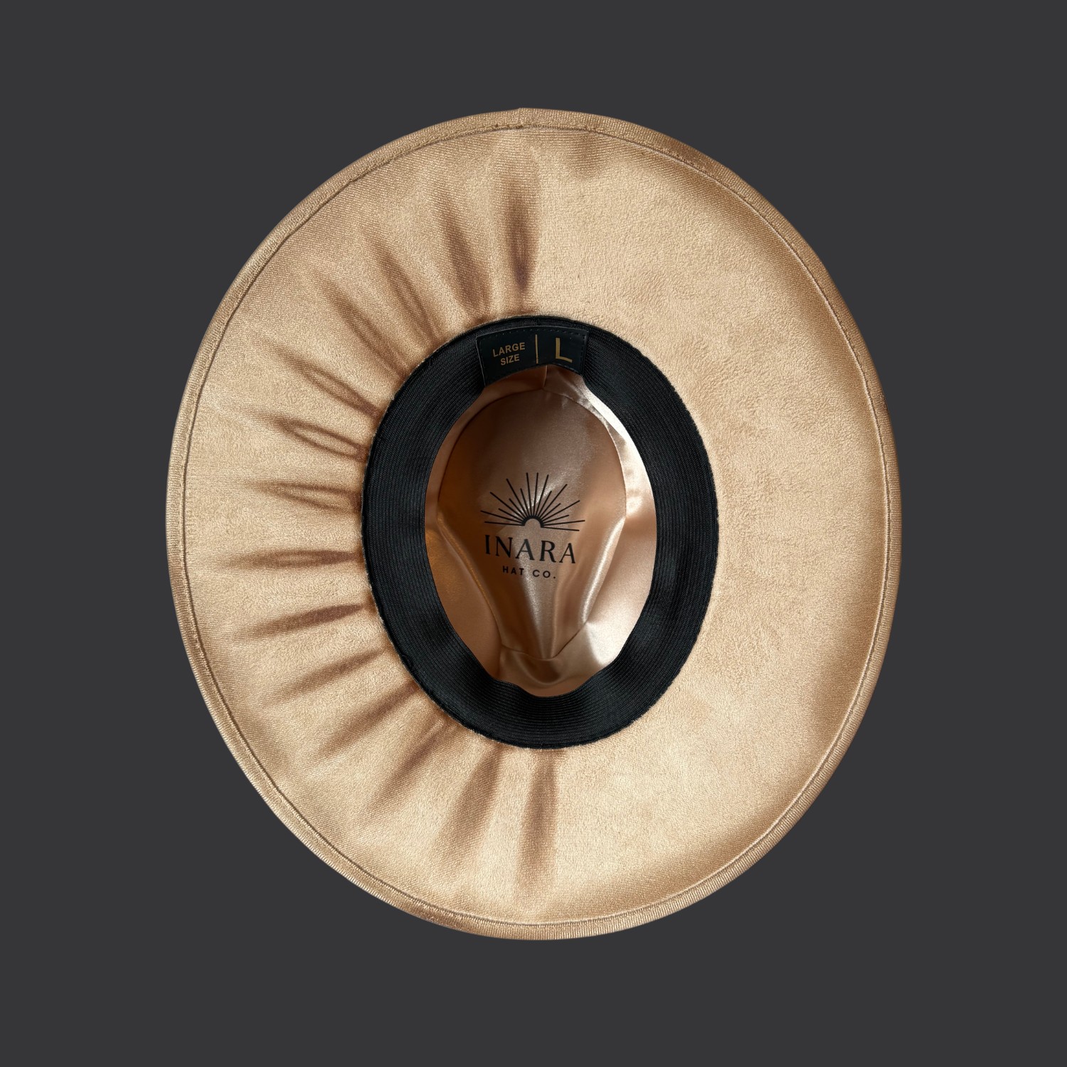 Under brim view of cream wide-brim hat showing hand-torched texture and embroidered “M B S” on crown