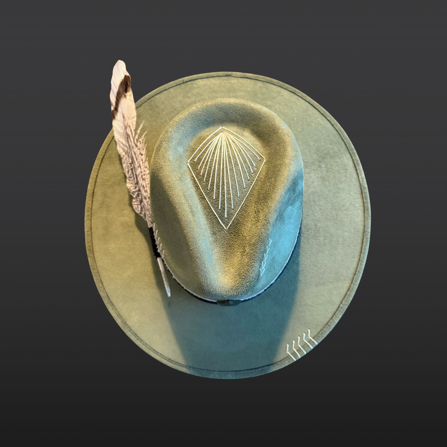 One of a kind sage green artisan fedora hat with obsidian stone, black leather band, white cotton wrap, feather detail, and hand embroidered directional symbols top view by Inara Hat Co.