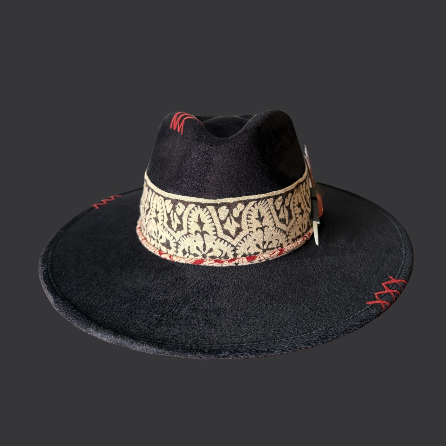 front view of one of a kind black fedora hat with red jasper, embroidered details, and feather accents