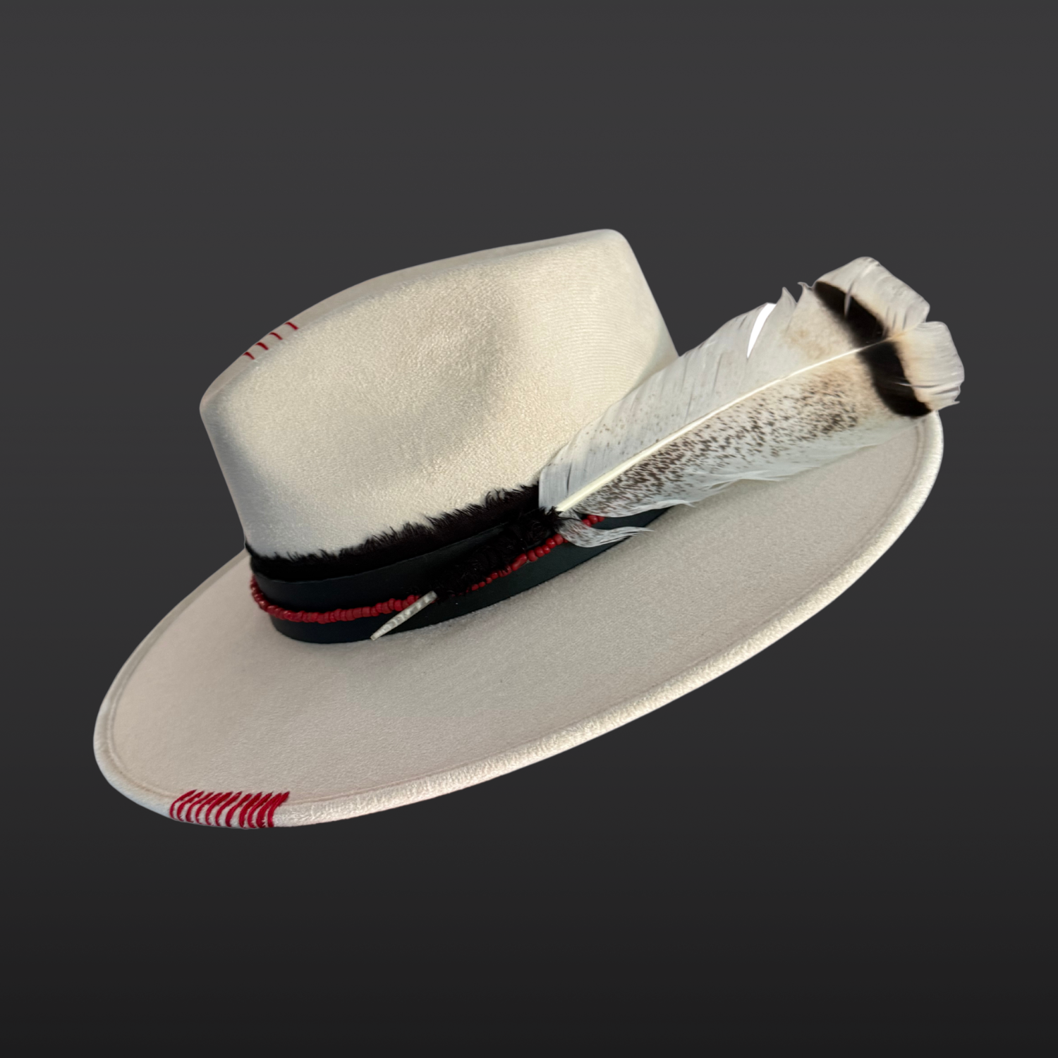 Ivory wide brim fedora hat with a black band, red beads, and a geometric bear paw embroidery.