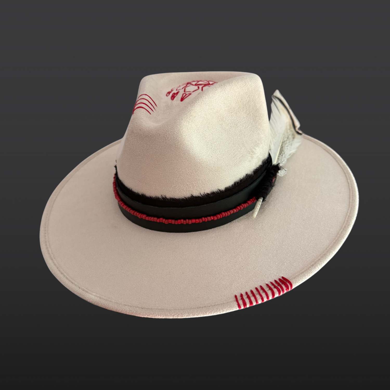 Right side view of Ivory vegan suede fedora with a black hat band and red bead accents.