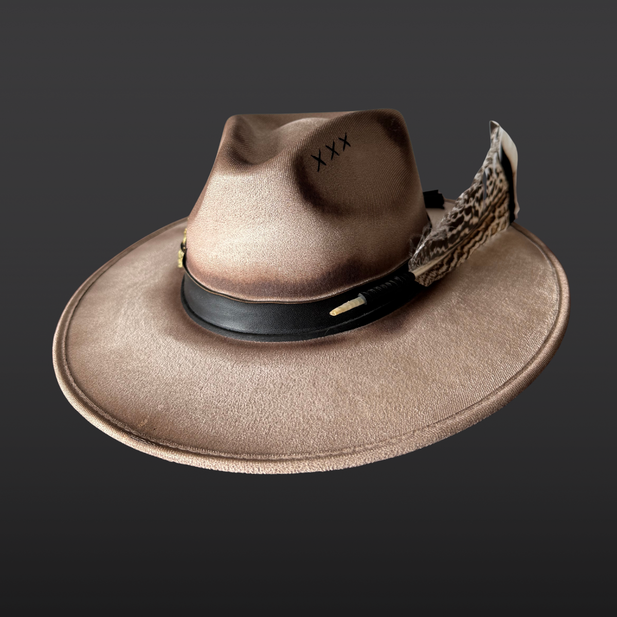Alternative Front view:
A wide-brimmed khaki fedora featuring subtle hand-embroidered details, a chalcopyrite crystal, black leather band, and turkey feather accents.