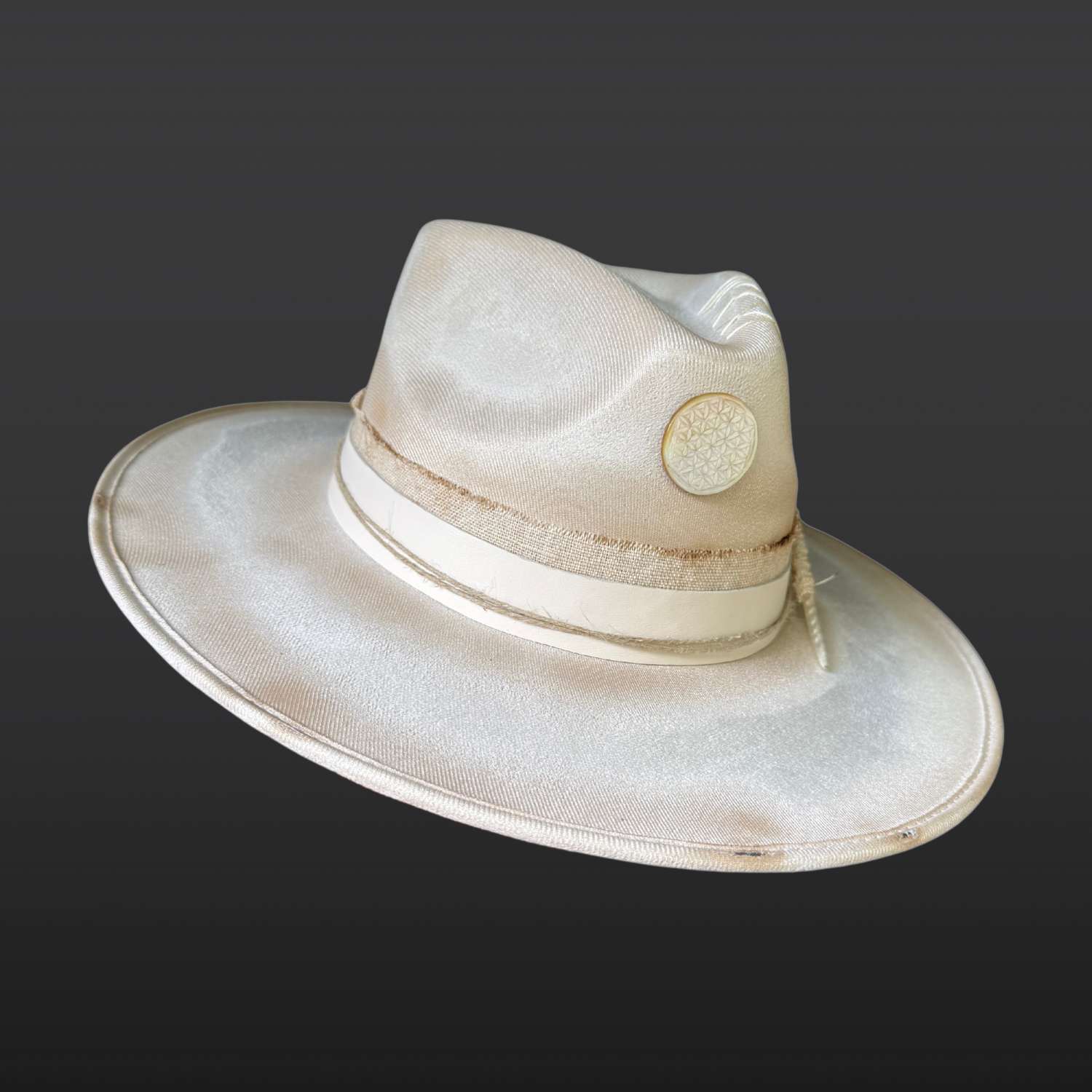 Wide-brim boho fedora in ivory vegan suede with fire-kissed accents and an ethically sourced turkey feather.