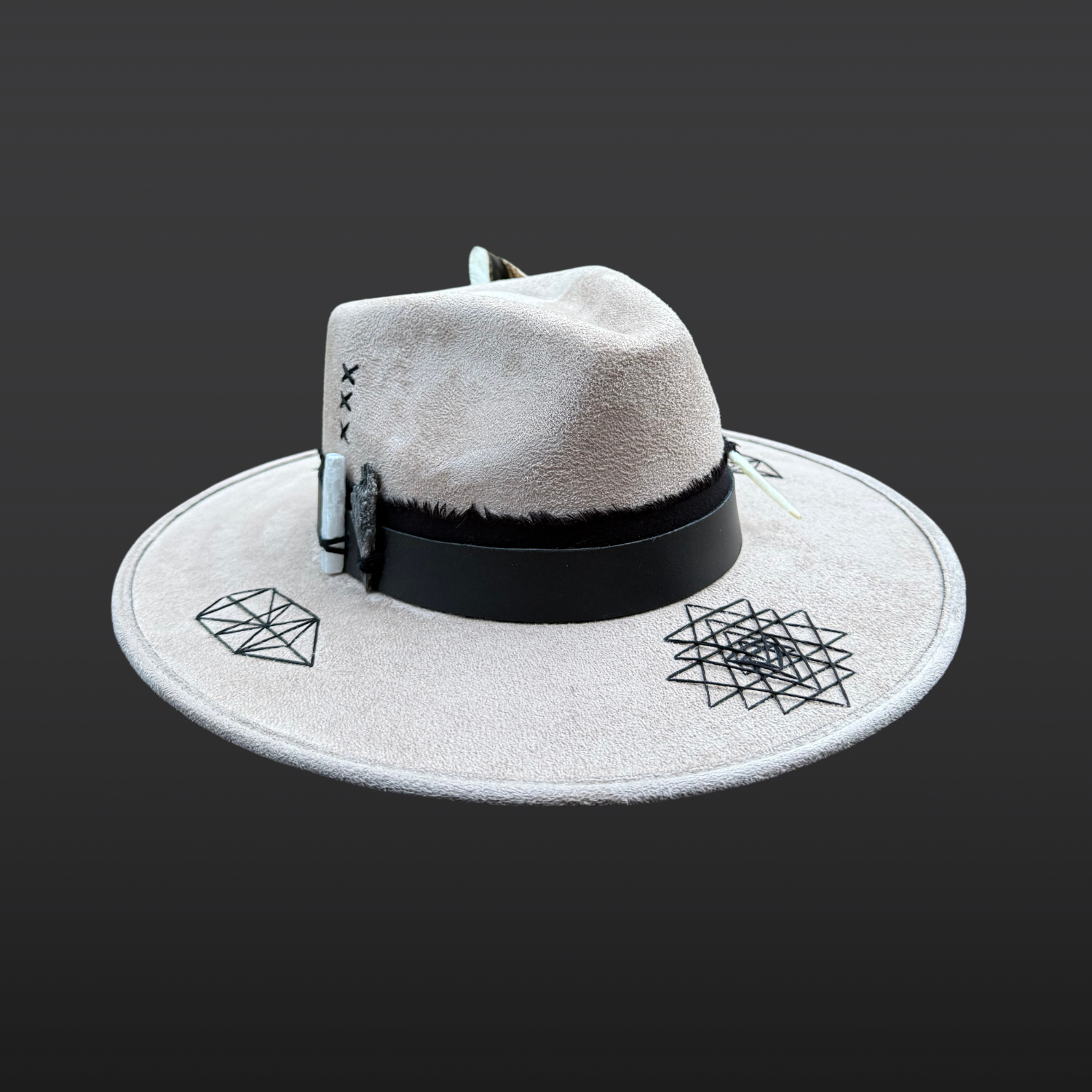 Angled front left view of Rooted Light fedora featuring Sri Yantra embroidery, black kyanite, selenite and turkey feather accents.