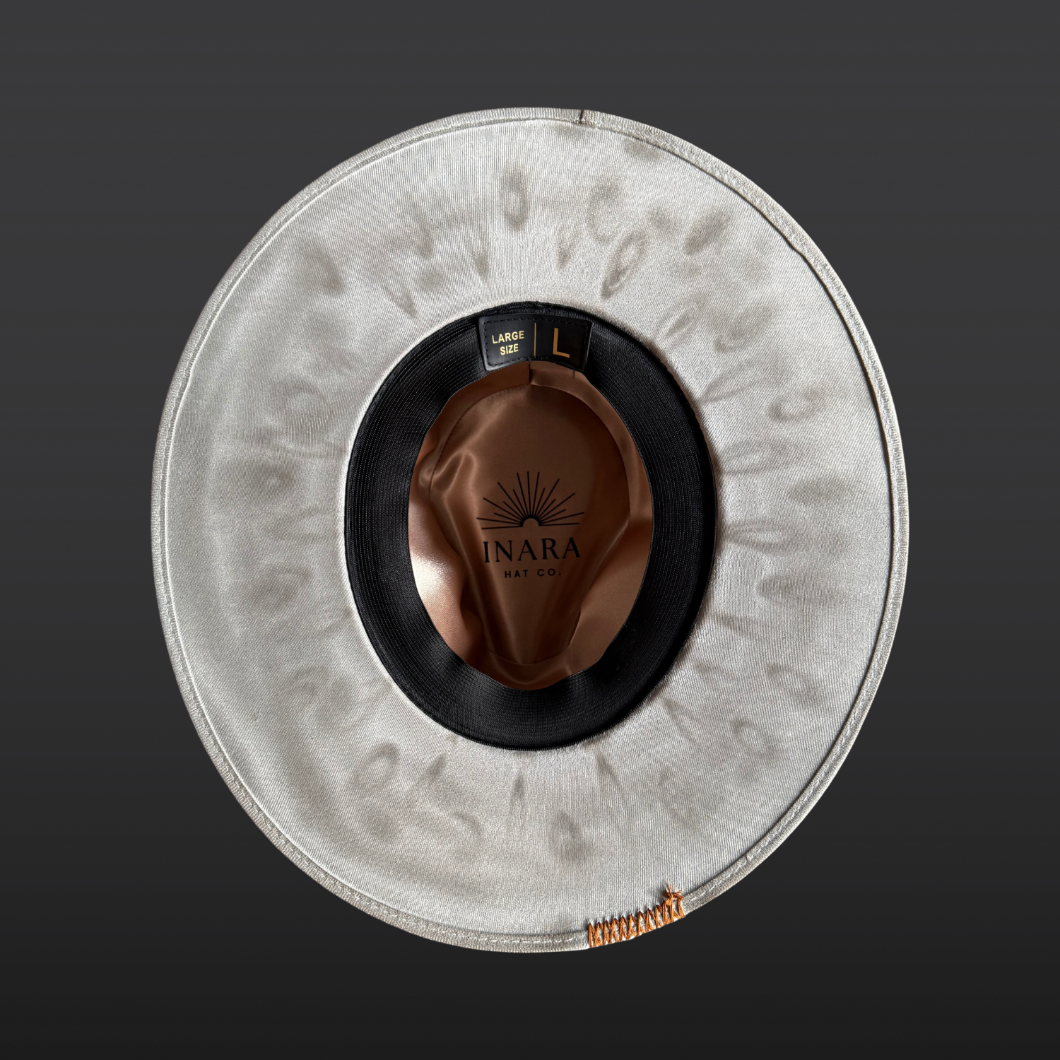 Hand-torched underside of the Wayfinder fedora showcasing artisan wood-burned detailing