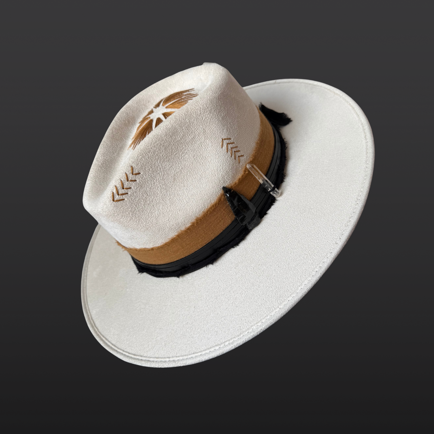 Ivory wide-brim fedora hat with sunburst embroidery, Lemurian quartz, obsidian arrow, leather band and feather detail