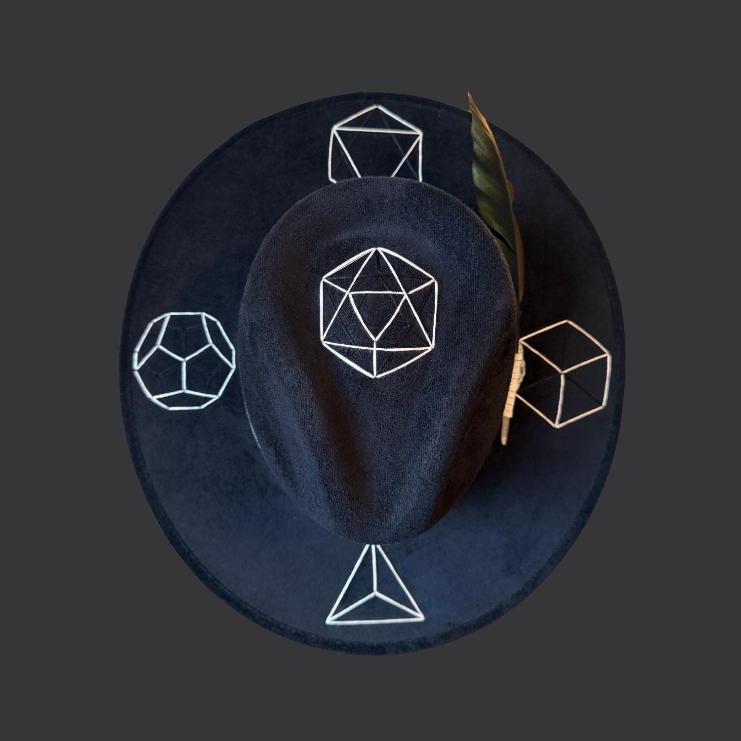 Black suede wide brim fedora with tree agate crystal, white leather band, and green black white duck feather / top view
